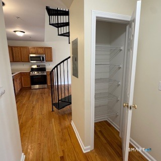 670 Boston Post Road, Unit 18 Milford, CT 06460 - Photo 3 of 18 a hallway with wooden floor and staircase