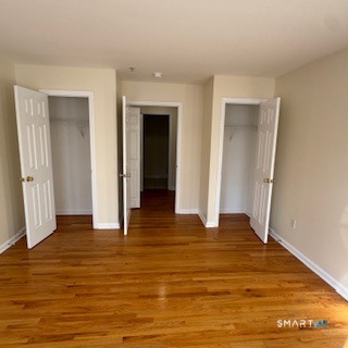 670 Boston Post Road, Unit 18 Milford, CT 06460 - Photo 5 of 18 a view of an empty room with wooden floor