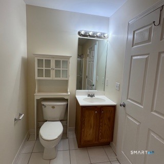 670 Boston Post Road, Unit 18 Milford, CT 06460 - Photo 8 of 18 a bathroom with a toilet sink and mirror