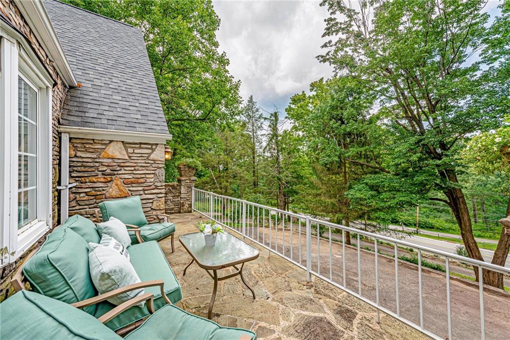1100 State Rt 30 Laughlintown, PA 15655 - Photo 8 of 50 a balcony with wooden floor and glass top table