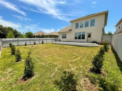 a front view of house with yard and swimming pool