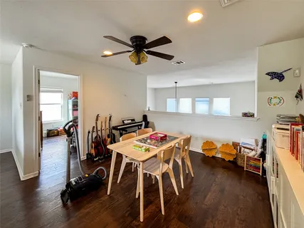 a dining room with furniture and wooden floor