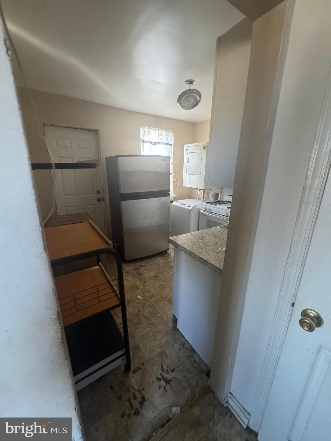 515 Cherry Hill Road Baltimore, MD 21225 - Photo 20 of 62 a kitchen with a refrigerator sink and cabinets