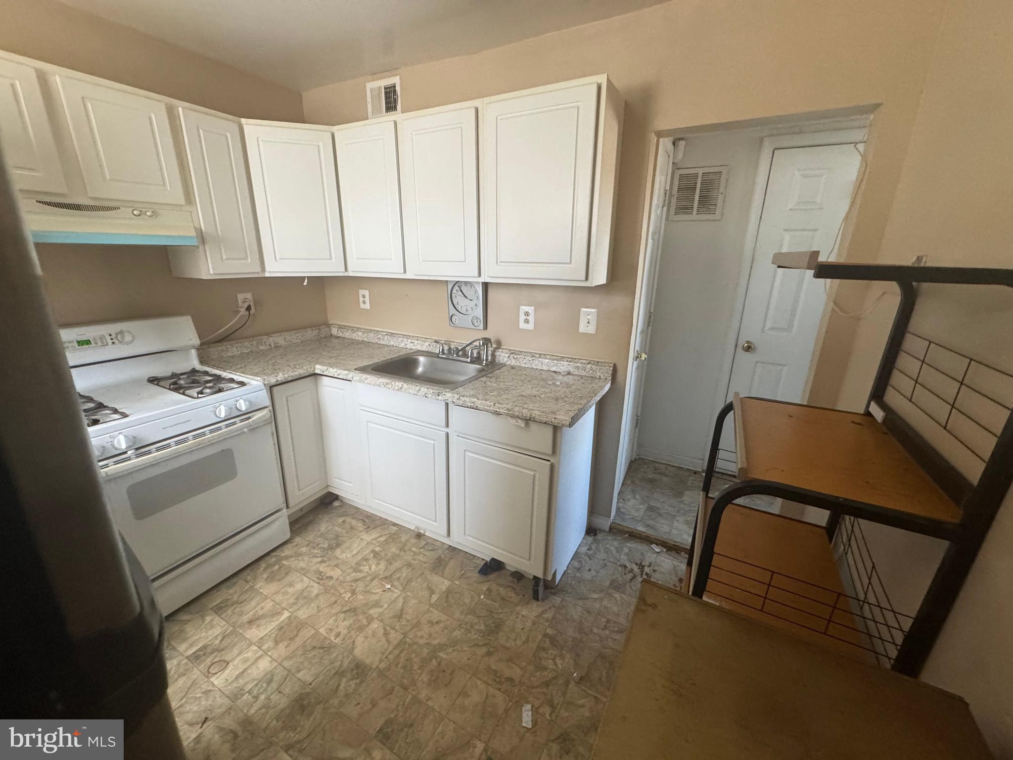 515 Cherry Hill Road Baltimore, MD 21225 - Photo 23 of 62 a kitchen with a stove sink and cabinets