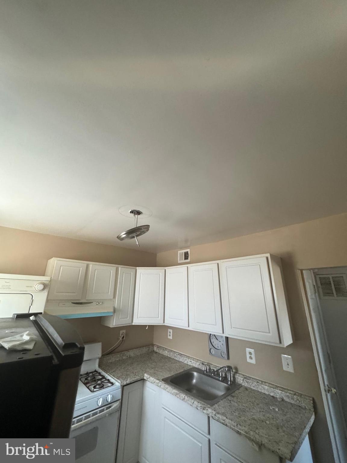 515 Cherry Hill Road Baltimore, MD 21225 - Photo 25 of 62 a kitchen with a sink and cabinets