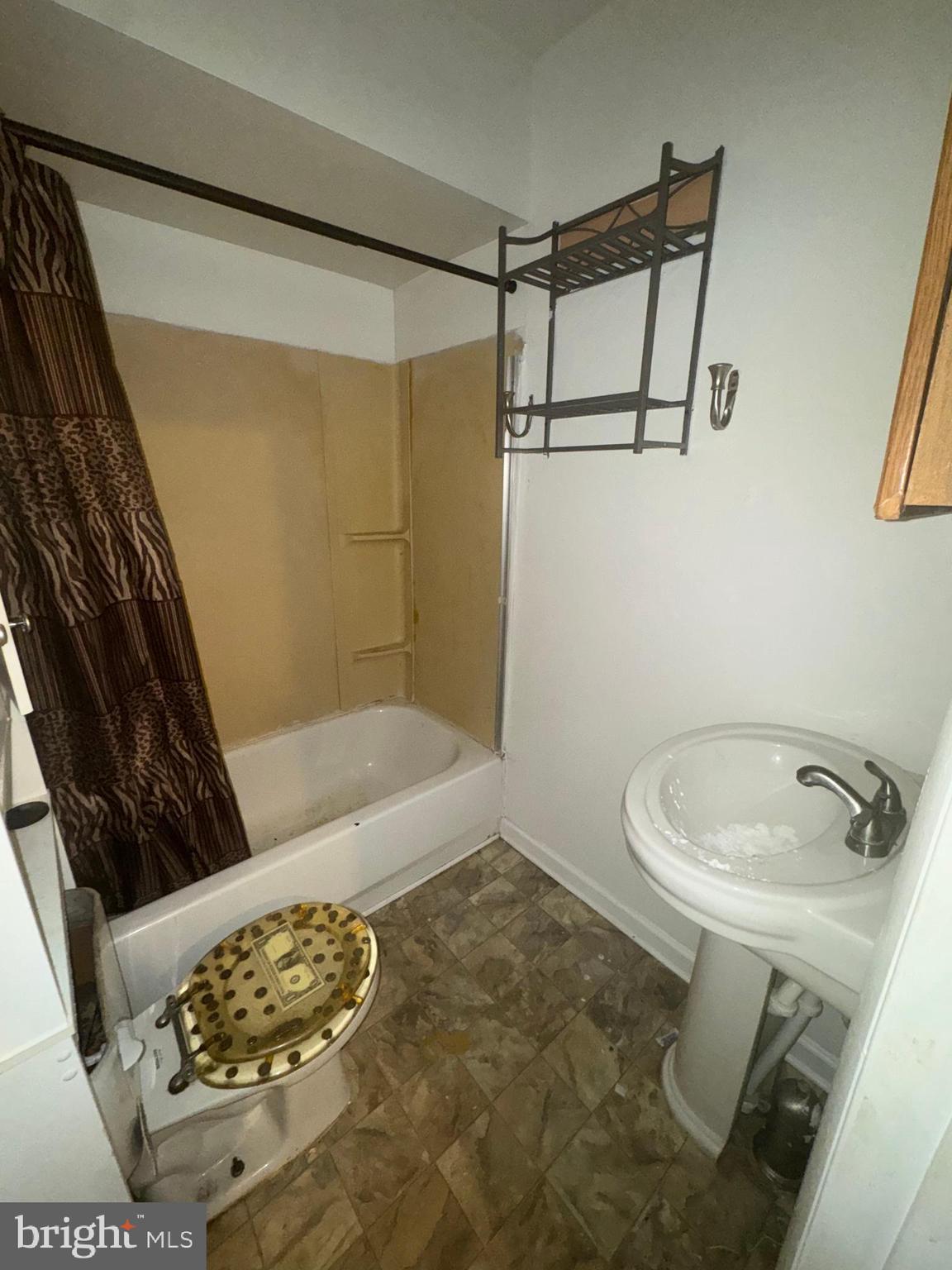 515 Cherry Hill Road Baltimore, MD 21225 - Photo 49 of 62 a bathroom with a sink toilet and shower