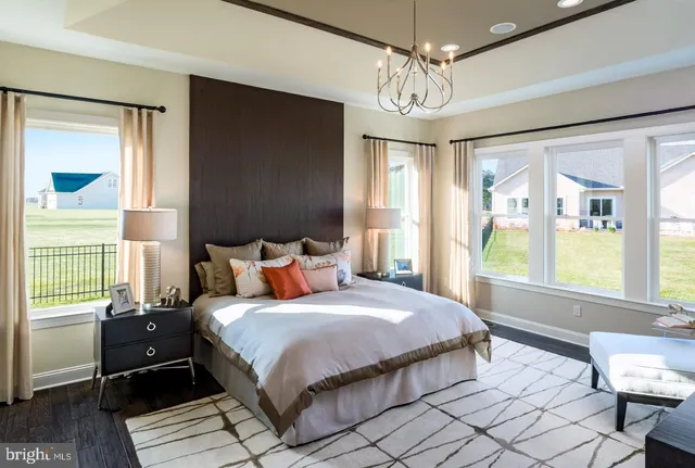 a spacious bedroom with a bed and a window