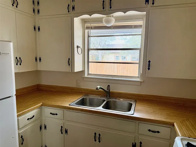 a kitchen with a sink and cabinets