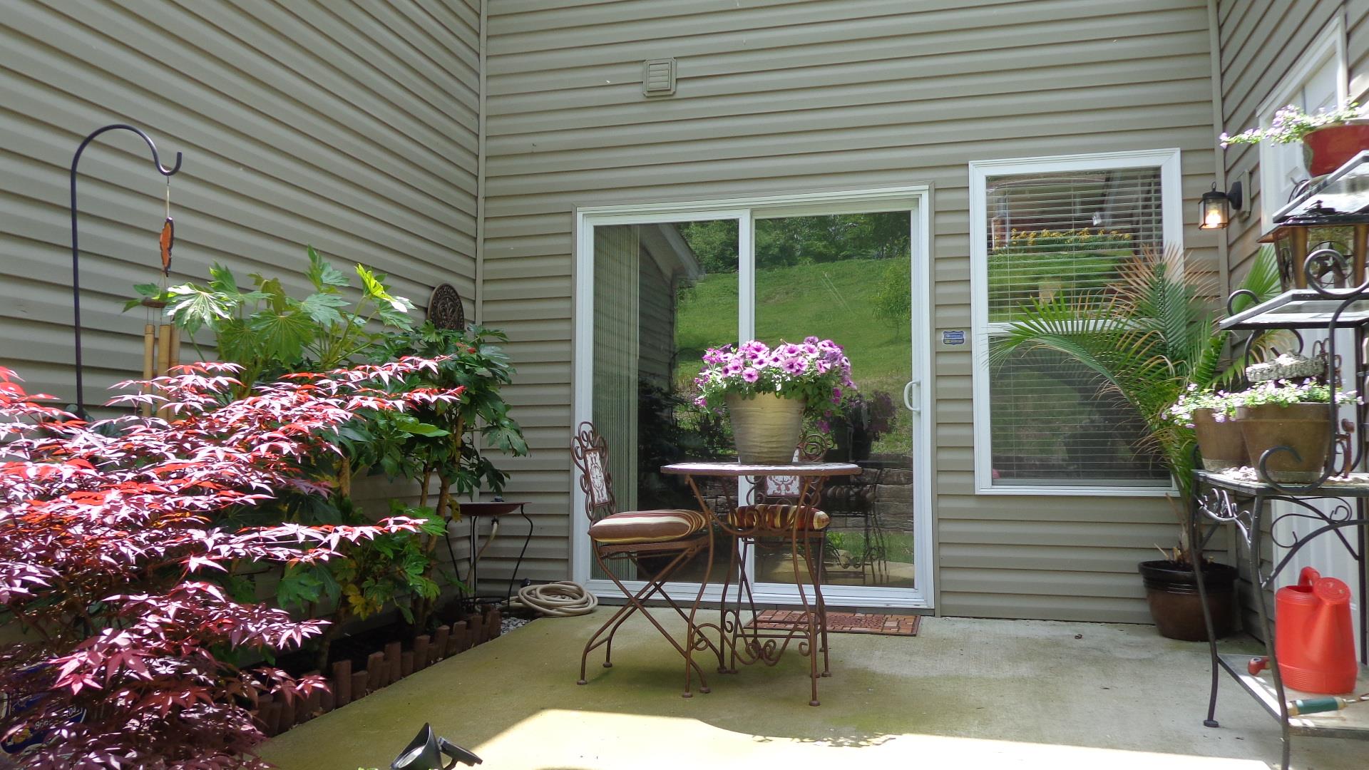 1382 Rural Hill Road, Unit 133 Antioch, TN 37013 - Photo 16 of 18 a house with a table and chairs and potted plants