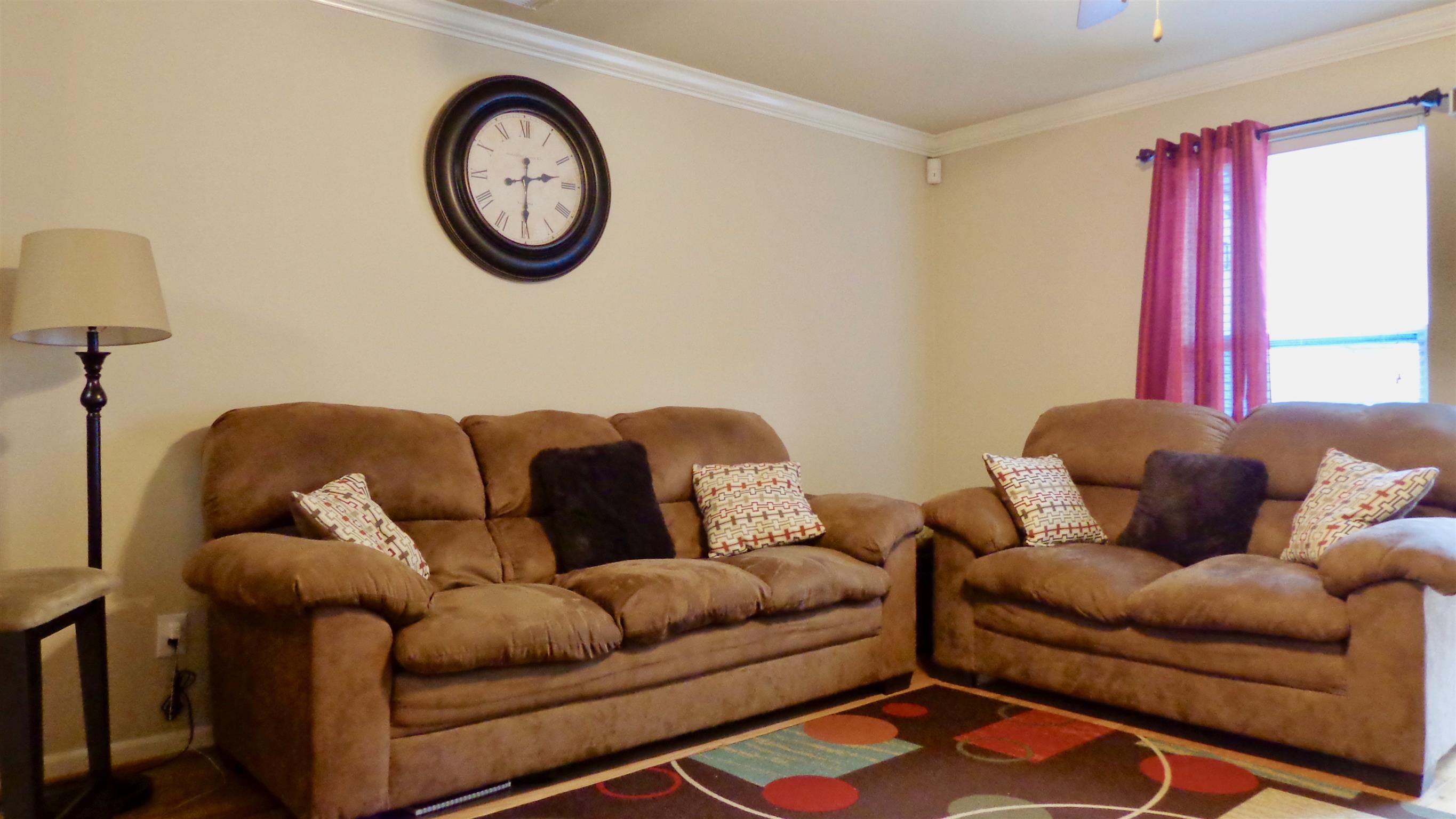 1382 Rural Hill Road, Unit 133 Antioch, TN 37013 - Photo 8 of 18 a living room with furniture a clock and a window
