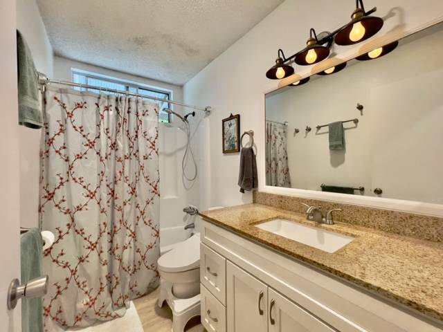 81-1010 St John's Road Kealakekua, HI 96750 - Photo 15 of 30 a bathroom with a granite countertop sink mirror vanity and toilet