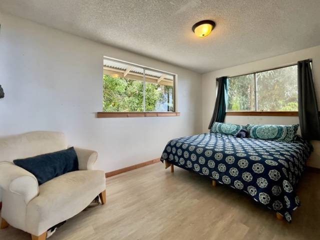 81-1010 St John's Road Kealakekua, HI 96750 - Photo 16 of 30 a bedroom with a bed and a couch