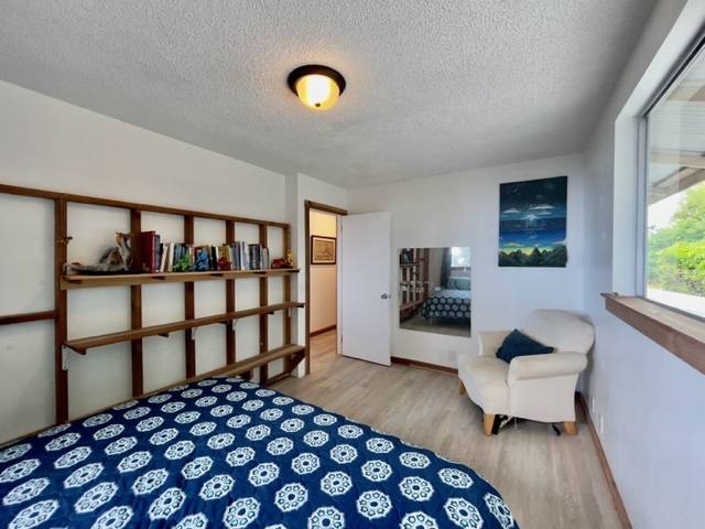 81-1010 St John's Road Kealakekua, HI 96750 - Photo 17 of 30 a bedroom with a bed and a couch
