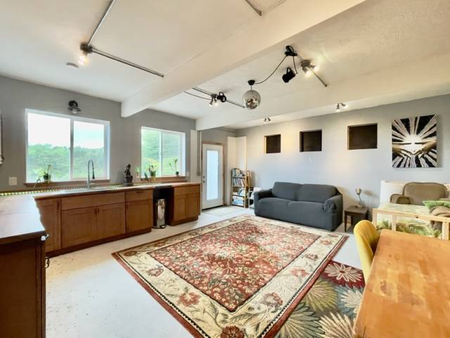 81-1010 St John's Road Kealakekua, HI 96750 - Photo 19 of 30 a large bedroom with a large bed a couch and a window
