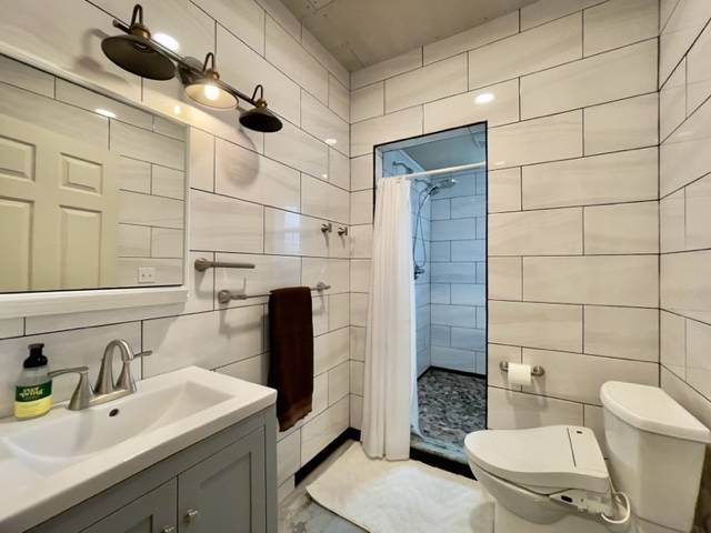 81-1010 St John's Road Kealakekua, HI 96750 - Photo 22 of 30 a bathroom with a sink a toilet and shower