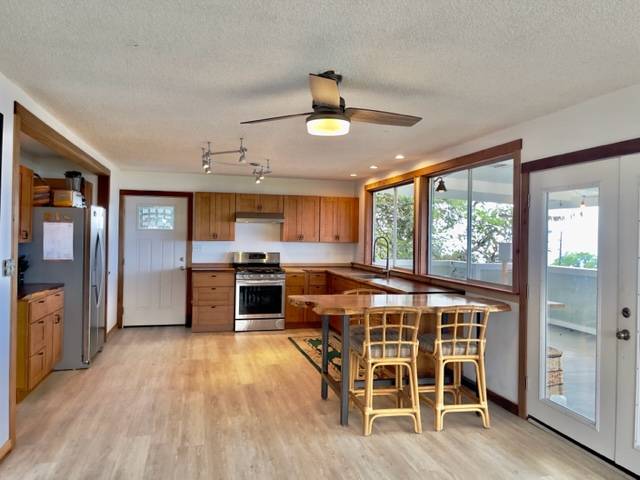 81-1010 St John's Road Kealakekua, HI 96750 - Photo 6 of 30 a kitchen with stainless steel appliances granite countertop a stove and a refrigerator