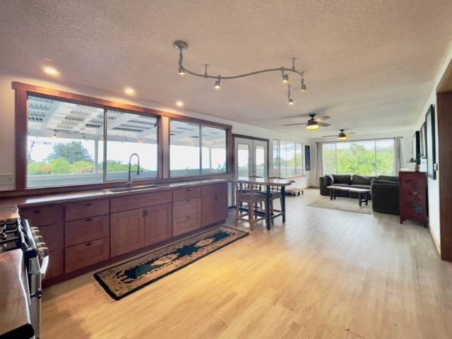 81-1010 St John's Road Kealakekua, HI 96750 - Photo 7 of 30 a room with lots of furniture and a large window