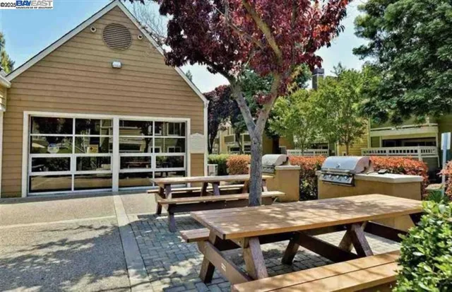 a view of a deck with table and chairs with wooden floor and fence