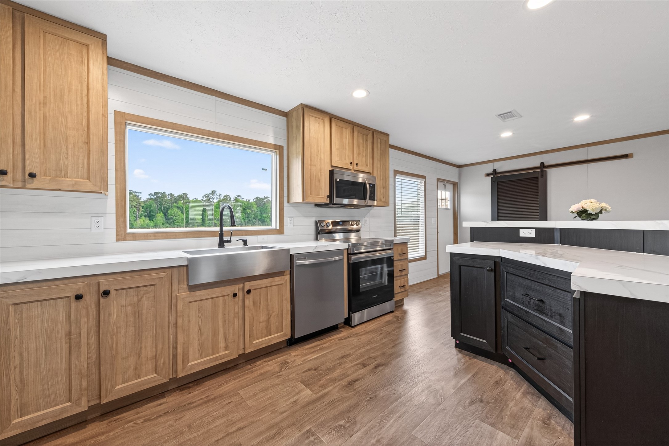 Stunning open-concept kitchen featuring modern finishes, stainless steel appliances, and a spacious center island that seamlessly connects to the living and dining areas, ideal for entertaining.