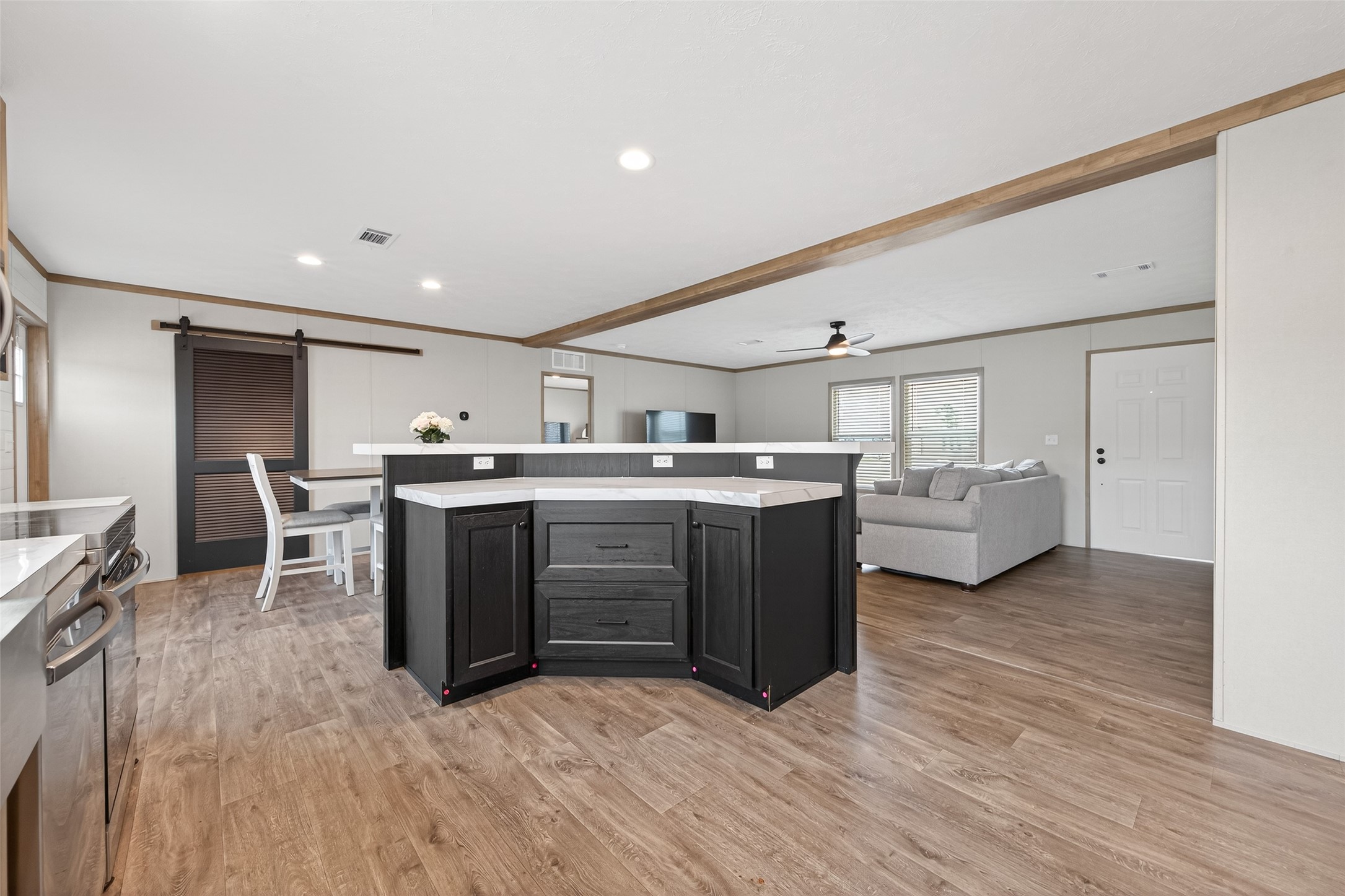 1218 Longleaf Pne Street Huffman, TX 77336 - Photo 5 of 29 Angle displaying the connection between kitchen, dining, and living areas, reinforcing the open-concept design.