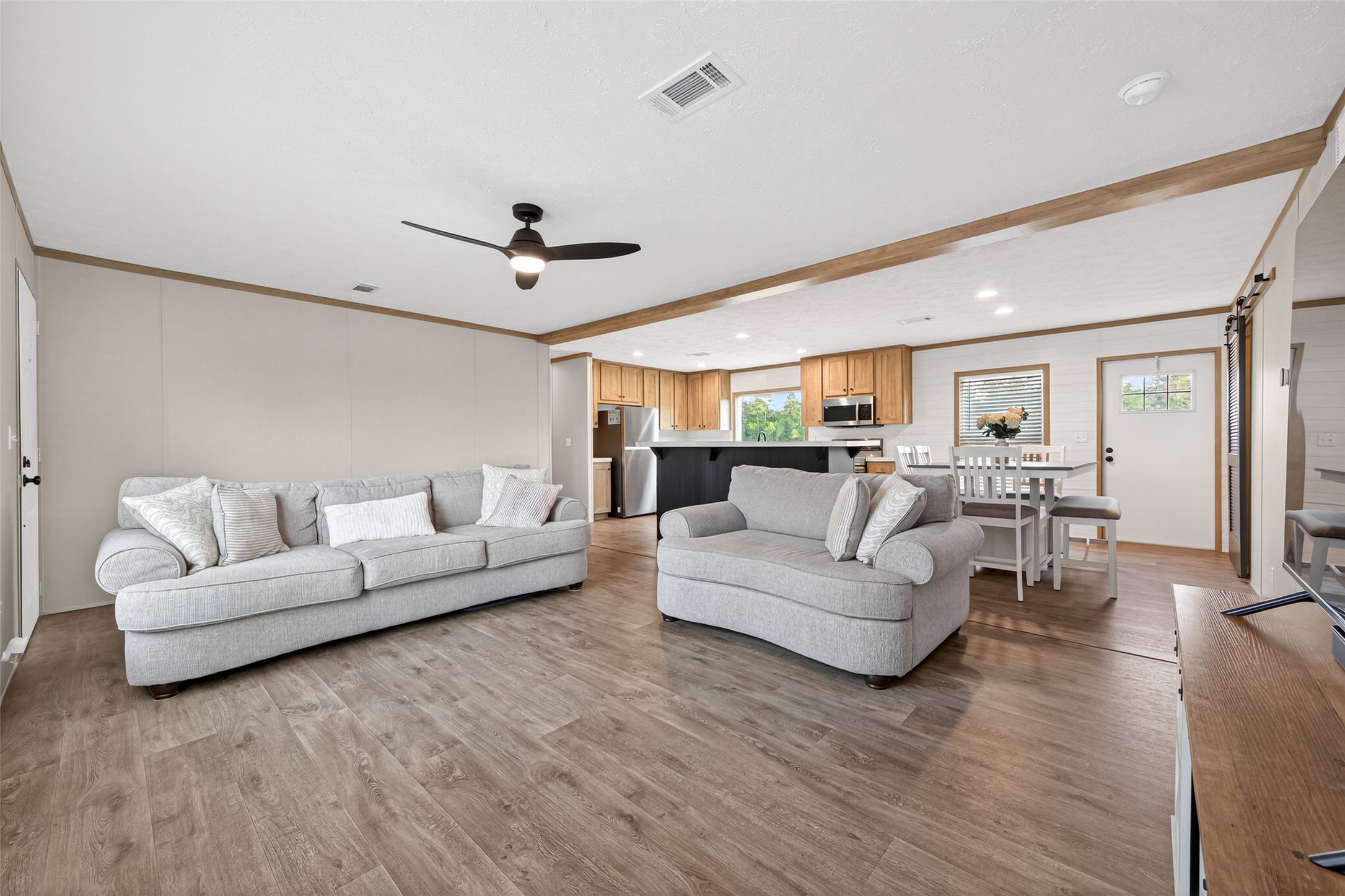 1218 Longleaf Pne Street Huffman, TX 77336 - Photo 6 of 29 Bright and spacious living room with an open-concept layout, seamlessly connected to the kitchen and dining areas, creating a perfect flow for everyday living and entertaining.