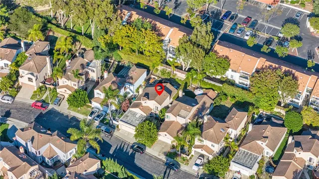 an aerial view of a residential house with a mountain
