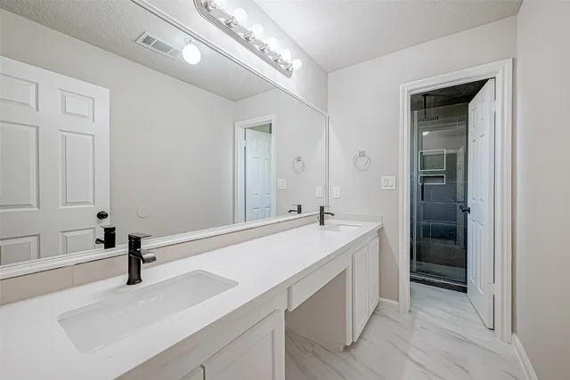 a spacious bathroom with a sink and a mirror