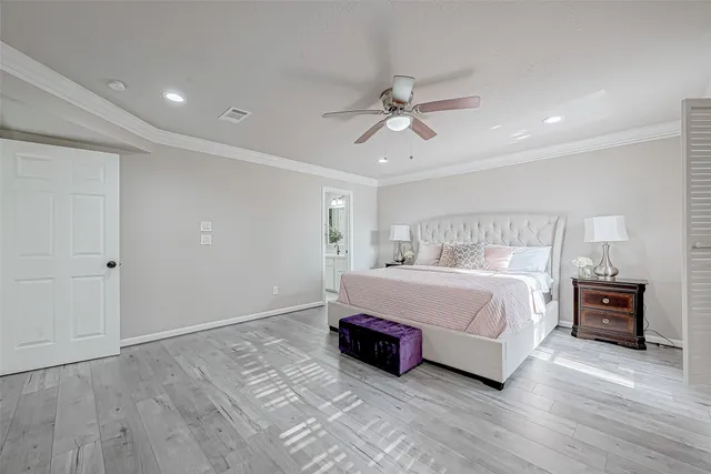 a spacious bedroom with a bed and a chandelier