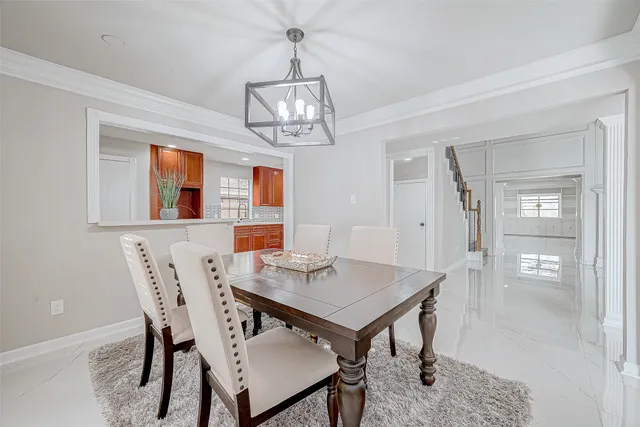a view of a dining room with furniture wooden floor and chandelier