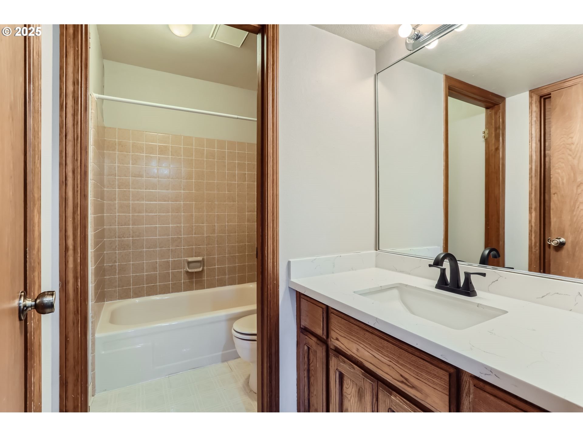 6518 Southwest 35th Avenue Portland, OR 97221 - Photo 15 of 36 a bathroom with a sink and a mirror