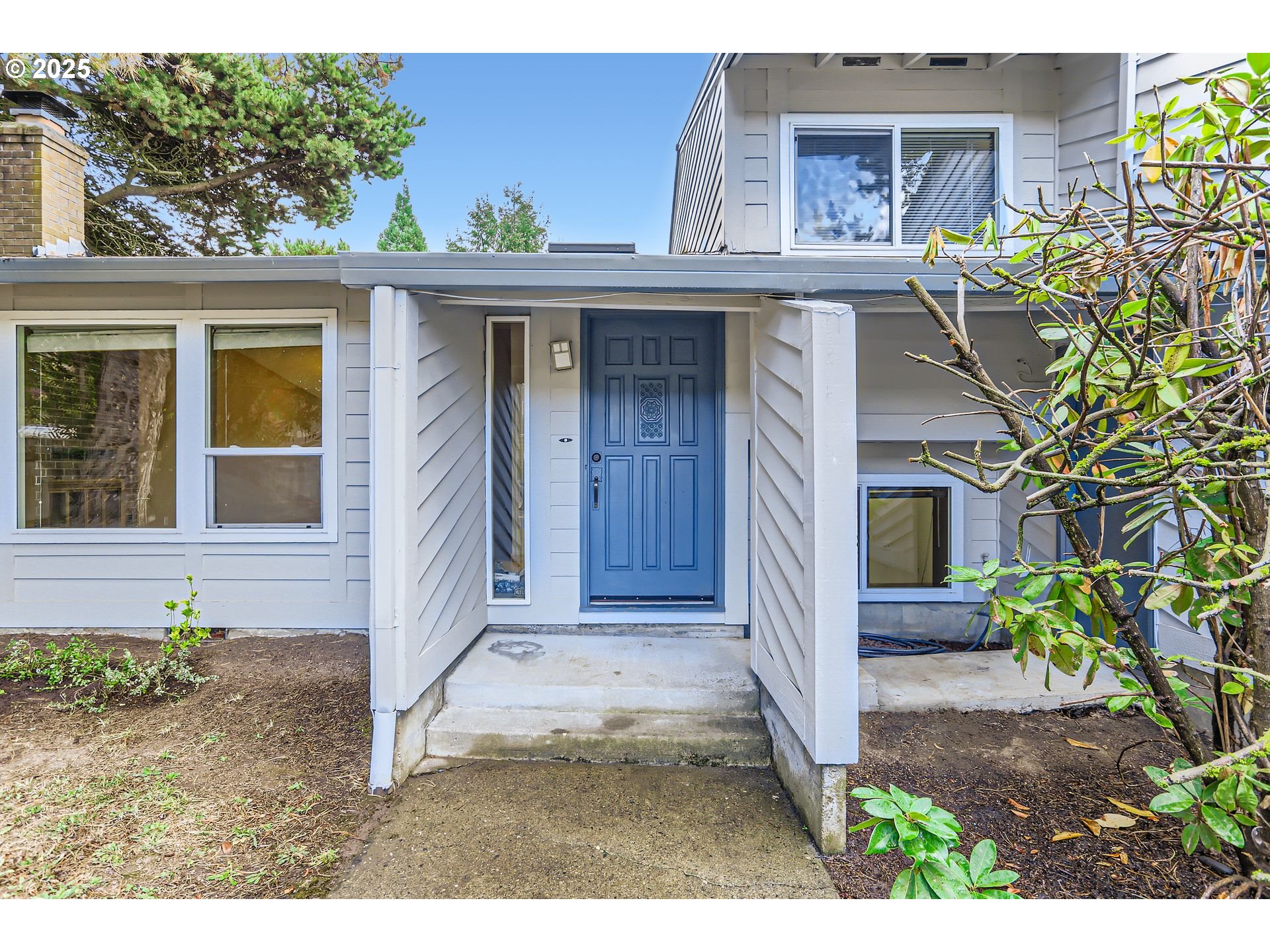 6518 Southwest 35th Avenue Portland, OR 97221 - Photo 2 of 36 a view of a house with potted plants and a garage