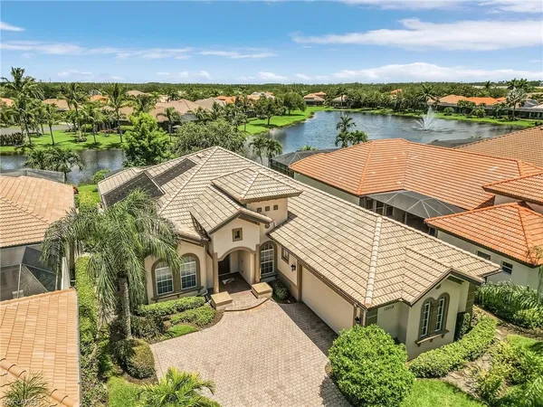 an aerial view of a house with a lake view