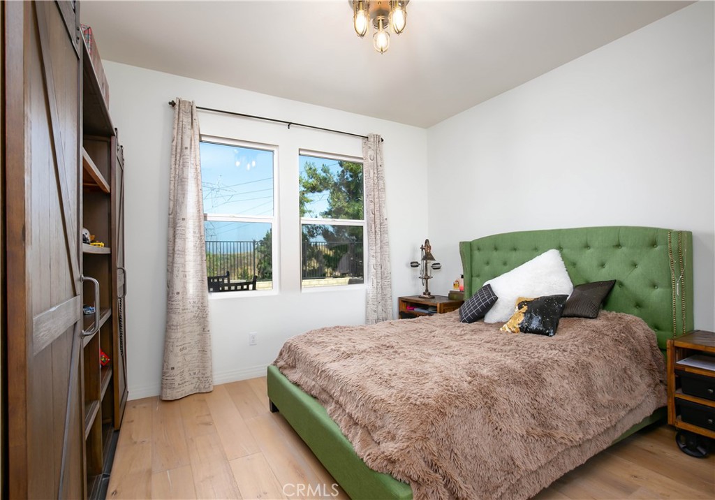 19680 Griffith Drive Saugus, CA 91350 - Photo 19 of 49 a bedroom with a bed dresser and a window
