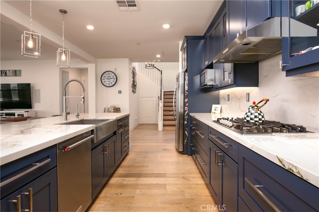 19680 Griffith Drive Saugus, CA 91350 - Photo 2 of 49 a large kitchen with stainless steel appliances granite countertop a stove and a sink