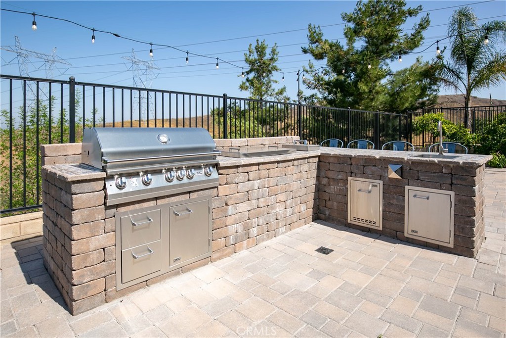 19680 Griffith Drive Saugus, CA 91350 - Photo 23 of 49 a kitchen with stainless steel appliances a stove and cabinets