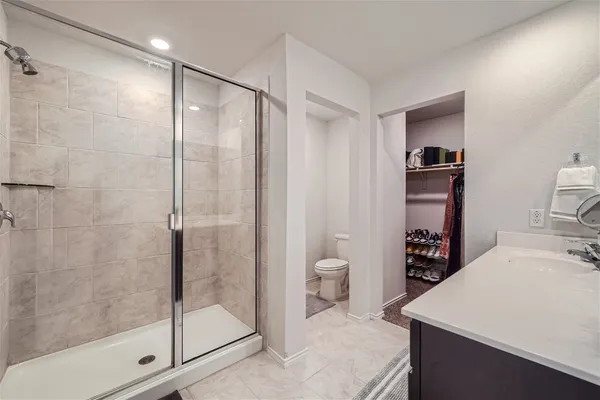 a en suite bathroom with a shower sink and toilet