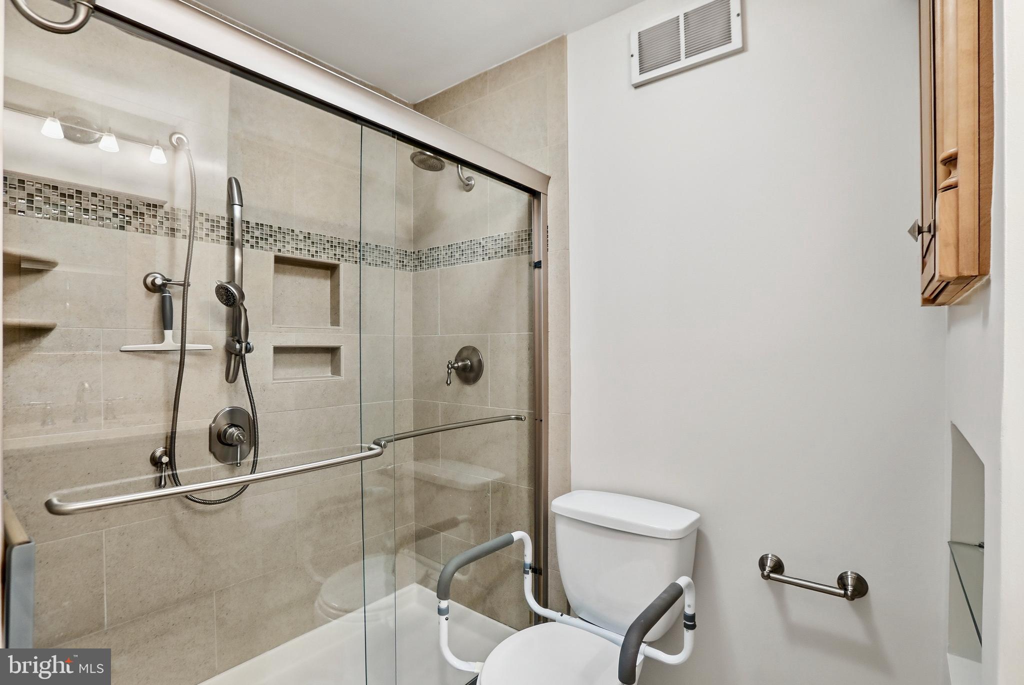 9202 Rockefeller Lane Springfield, VA 22153 - Photo 11 of 38 a bathroom with a toilet and a shower