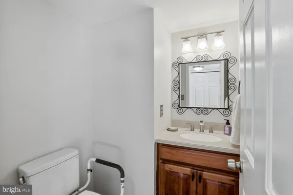 a bathroom with a toilet sink and mirror