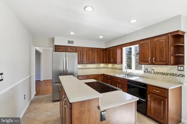 a kitchen with a sink a stove and cabinets