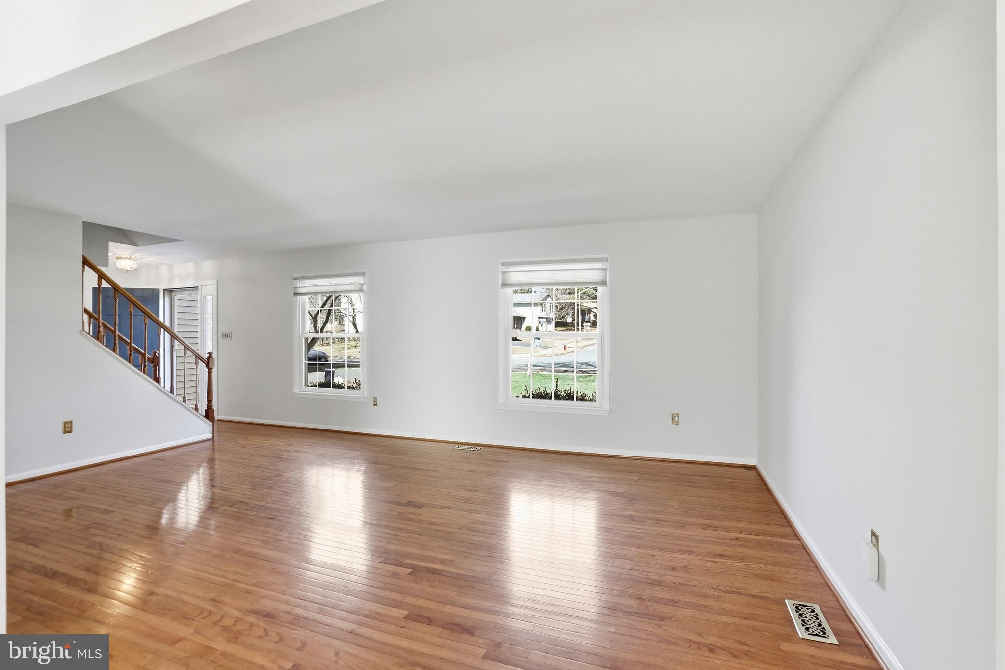 9202 Rockefeller Lane Springfield, VA 22153 - Photo 22 of 38 a view of an empty room with wooden floor and a window