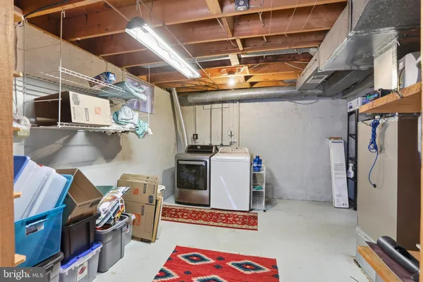 a view of deck with large trees and wooden fence