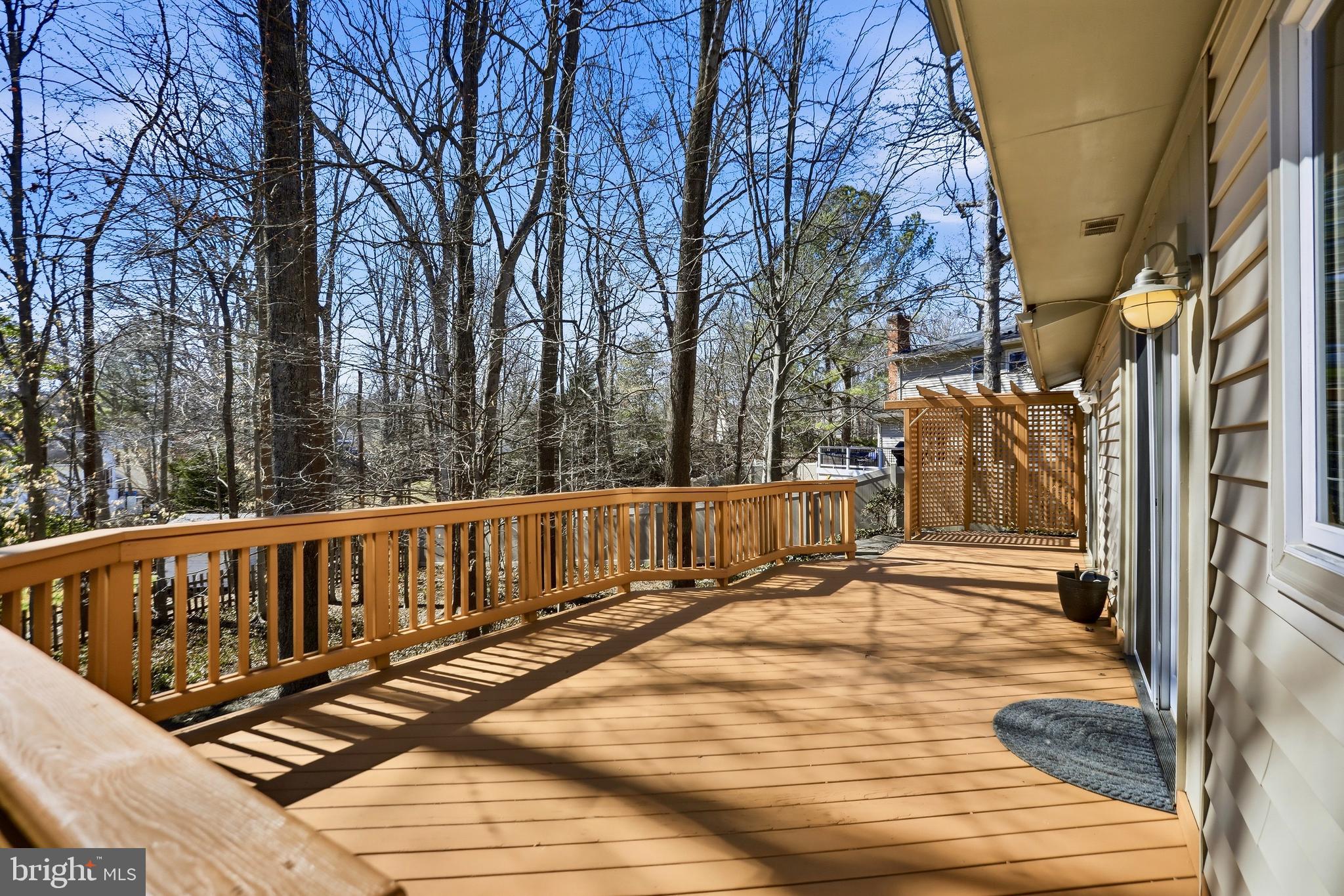 9202 Rockefeller Lane Springfield, VA 22153 - Photo 29 of 38 a view of deck with large trees and wooden fence