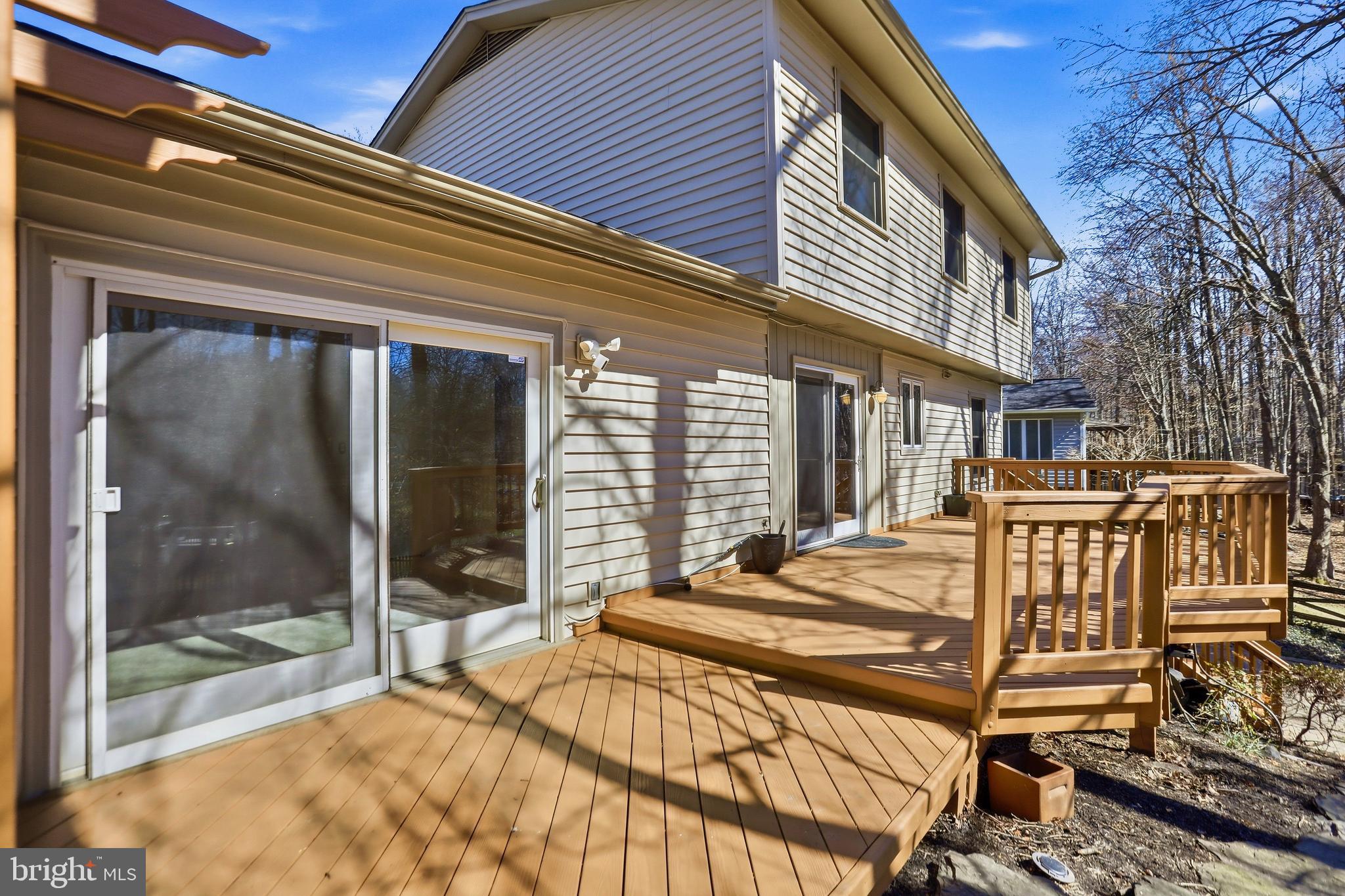 9202 Rockefeller Lane Springfield, VA 22153 - Photo 30 of 38 a view of a patio with a table and chairs and floor to ceiling window with yard