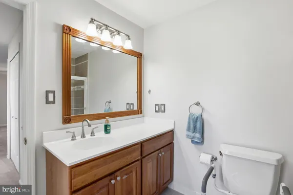 a bathroom with a sink vanity and a mirror