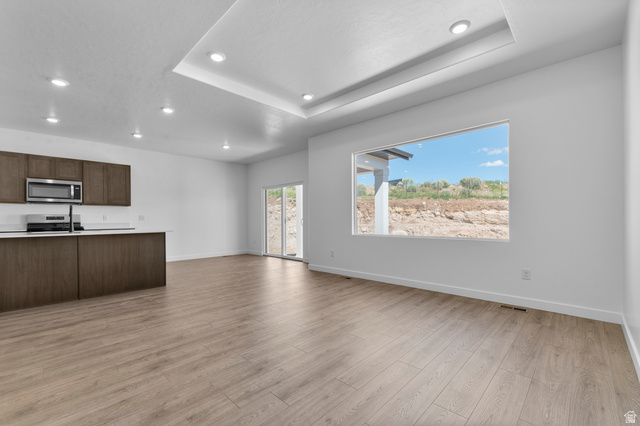 1338 West 2350 South, Unit 19 Perry, UT 84302 - Photo 4 of 14 Open-concept living space with wood-finish flooring