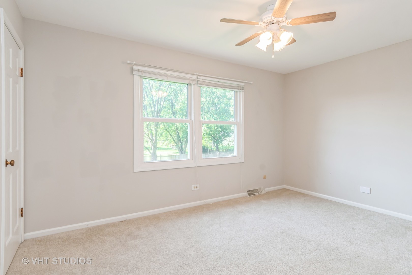 76 West Bailey Road Naperville, IL 60565 - Photo 12 of 20 an empty room with a window and a fan