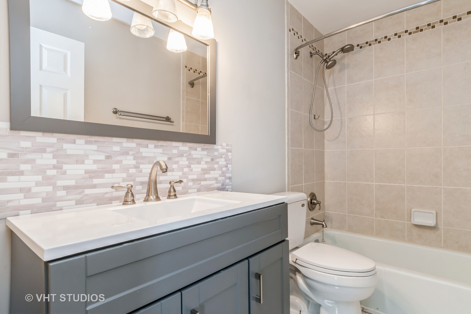 76 West Bailey Road Naperville, IL 60565 - Photo 13 of 20 a bathroom with a sink toilet vanity and shower