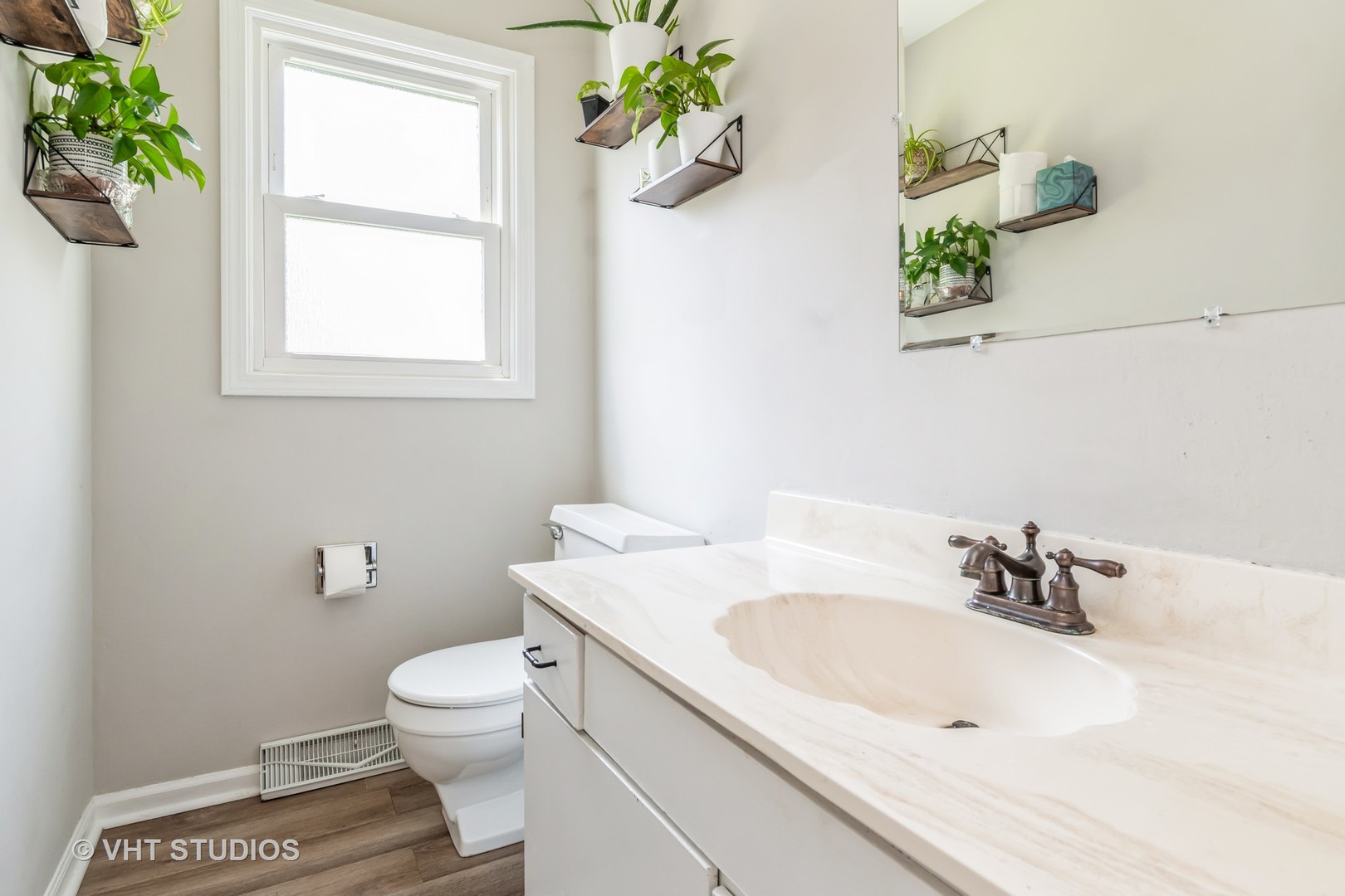 76 West Bailey Road Naperville, IL 60565 - Photo 16 of 20 a bathroom with a sink a toilet and a window