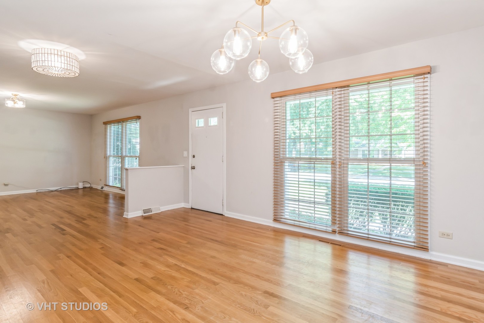 76 West Bailey Road Naperville, IL 60565 - Photo 3 of 20 a view of an empty room with wooden floor and a window