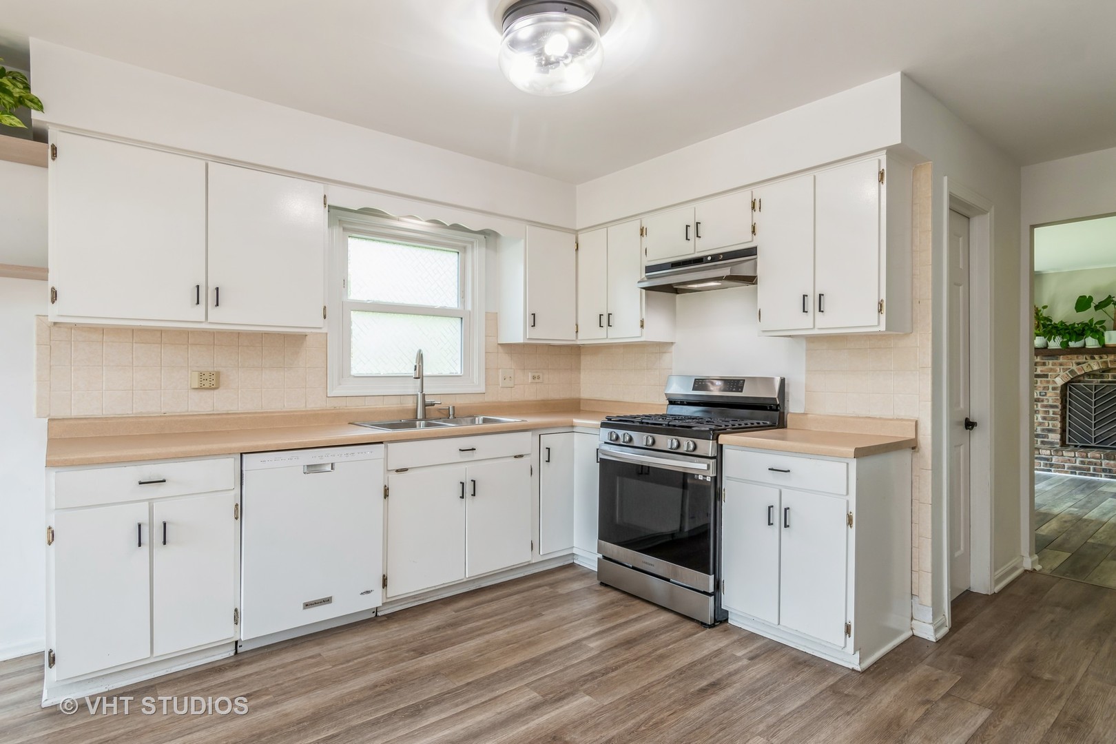 76 West Bailey Road Naperville, IL 60565 - Photo 4 of 20 a kitchen with cabinets stainless steel appliances and a window